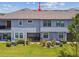 Back of the townhome with screened patio and lush lawn at 4653 Ancona Way, Wesley Chapel, FL 33543