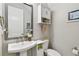 Charming half bathroom boasts a pedestal sink, art, and gray paint at 4653 Ancona Way, Wesley Chapel, FL 33543