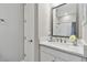Stylish bathroom featuring a modern vanity, framed mirror, and shower-tub combination at 4653 Ancona Way, Wesley Chapel, FL 33543