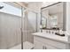Bright bathroom with a sink and glass enclosed shower at 4653 Ancona Way, Wesley Chapel, FL 33543