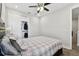 Bedroom with a ceiling fan and a closet with sliding doors at 4653 Ancona Way, Wesley Chapel, FL 33543
