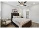 Cozy bedroom features a plush bed, soft chair, and a closet with shelving at 4653 Ancona Way, Wesley Chapel, FL 33543