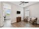 Bonus room features wood floors, fan, and adjacent office area at 4653 Ancona Way, Wesley Chapel, FL 33543