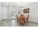 Bright dining area with a round table, wood chairs, and a sliding glass door to the backyard at 4653 Ancona Way, Wesley Chapel, FL 33543