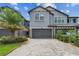 Stylish two-story townhome with a two-car garage, beautiful landscaping, and brick paver driveway at 4653 Ancona Way, Wesley Chapel, FL 33543