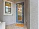 Charming front door with decorative wreath, a welcome mat, and a sidelight window at 4653 Ancona Way, Wesley Chapel, FL 33543