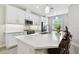 Kitchen island with quartz countertop with stainless steel appliances and overhead microwave at 4653 Ancona Way, Wesley Chapel, FL 33543