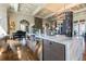 Open kitchen with marble countertops, stainless steel appliances, and modern lighting fixtures at 4653 Ancona Way, Wesley Chapel, FL 33543
