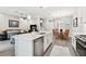 Spacious kitchen with island offering seating for casual dining and views of the living area at 4653 Ancona Way, Wesley Chapel, FL 33543