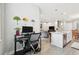 The office and desk setup is beside the kitchen and overlooks the living room and dining room at 4653 Ancona Way, Wesley Chapel, FL 33543
