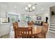 Open-concept living space features a dining area, kitchen island, and comfortable seating area at 4653 Ancona Way, Wesley Chapel, FL 33543