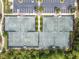 Aerial view of four tennis courts with parking and lush greenery surrounding the area at 4653 Ancona Way, Wesley Chapel, FL 33543