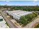 Aerial view showcasing modern townhomes surrounded by lush trees and the city skyline in the distance at 5008 S Macdill Ave # 16, Tampa, FL 33611