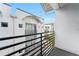 Balcony with black metal railings provides a view of surrounding white buildings and lush greenery at 5008 S Macdill Ave # 16, Tampa, FL 33611