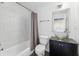 This bathroom features a glass vessel sink atop a black vanity, paired with white tiled walls at 5008 S Macdill Ave # 16, Tampa, FL 33611