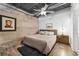 Bedroom featuring exposed ductwork, a ceiling fan, brick accent wall and a decorative rug at 5008 S Macdill Ave # 16, Tampa, FL 33611