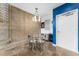 Dining area with a modern chandelier, round table, and a painted accent wall in a unique industrial space at 5008 S Macdill Ave # 16, Tampa, FL 33611