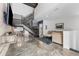 An open-concept living room with modern decor, exposed concrete floors, and industrial-style stairs at 5008 S Macdill Ave # 16, Tampa, FL 33611
