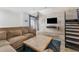 Open-concept living area featuring a comfortable sofa, modern decor, and a nearby staircase at 5008 S Macdill Ave # 16, Tampa, FL 33611
