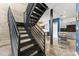 Industrial staircase with metal railing leading to kitchen and dining area with modern finishes at 5008 S Macdill Ave # 16, Tampa, FL 33611