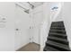 Stairwell features metal stairs with white walls, an entry door, and modern details at 5008 S Macdill Ave # 16, Tampa, FL 33611