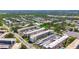 Overhead view of condo complex surrounded by parking, trees and other neighborhood dwellings at 5603 80Th N St # 103, St Petersburg, FL 33709