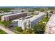An aerial view showcases a well maintained condo community with parking, and landscaping at 5603 80Th N St # 103, St Petersburg, FL 33709