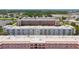 An aerial shot showcases a meticulously maintained condo community with mature trees and lots of parking at 5603 80Th N St # 103, St Petersburg, FL 33709