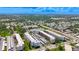 Extensive aerial shot of condo buildings surrounded by trees, neighborhood homes and plenty of parking spaces at 5603 80Th N St # 103, St Petersburg, FL 33709