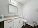 Bathroom featuring a granite countertop vanity and wood-look floors at 5603 80Th N St # 103, St Petersburg, FL 33709