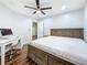 Bedroom with a ceiling fan, wood-look floors, and workspace with a desk and chair at 5603 80Th N St # 103, St Petersburg, FL 33709