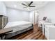Bedroom featuring wood-look floors, a desk and chair, and a ceiling fan at 5603 80Th N St # 103, St Petersburg, FL 33709