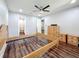 Bedroom featuring hardwood floors, a ceiling fan, unfinished wooden furniture, and an en suite bathroom at 5603 80Th N St # 103, St Petersburg, FL 33709