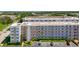 The exterior of a condo building with covered parking, and tropical landscaping at 5603 80Th N St # 103, St Petersburg, FL 33709