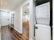 Hallway with view into bedroom, unit entrance and laundry closet with stackable at 5603 80Th N St # 103, St Petersburg, FL 33709