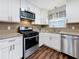 Renovated kitchen featuring stainless steel appliances, granite countertops, and white cabinetry at 5603 80Th N St # 103, St Petersburg, FL 33709