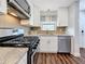 Kitchen with granite countertops, tile backsplash, stainless steel appliances, and modern faucet at 5603 80Th N St # 103, St Petersburg, FL 33709