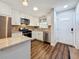 Charming kitchen featuring updated appliances, wood floors and white cabinets at 5603 80Th N St # 103, St Petersburg, FL 33709