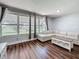 Living room featuring a large window bringing in ample light, with a white L-shaped couch and wooden coffee table at 5603 80Th N St # 103, St Petersburg, FL 33709