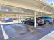 Community parking area with multiple cars parked under the carport at 5603 80Th N St # 103, St Petersburg, FL 33709