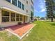 View of the patio from a condominium unit on a manicured lawn at 5603 80Th N St # 103, St Petersburg, FL 33709