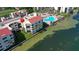 Aerial of waterfront community featuring pool, boat docks and lush landscaping at 5633 Puerta Del Sol S Blvd # 204, St Petersburg, FL 33715