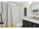Bright bathroom with white tiling, modern vanity, and stylish round mirror at 5633 Puerta Del Sol S Blvd # 204, St Petersburg, FL 33715