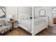 Comfortable bedroom features a four-poster bed, wooden floors, and stylish furnishings at 5633 Puerta Del Sol S Blvd # 204, St Petersburg, FL 33715