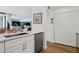 Bright kitchen with white cabinets and countertops offering a view into the dining area at 5633 Puerta Del Sol S Blvd # 204, St Petersburg, FL 33715