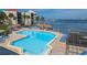 Beautiful swimming pool area with tiki umbrellas, lounge chairs, and ocean views at 5633 Puerta Del Sol S Blvd # 204, St Petersburg, FL 33715
