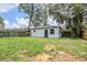Backyard view of a house with a fenced perimeter at 5847 Harrison St, New Port Richey, FL 34653