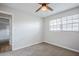Bedroom featuring neutral carpet, a window, and access to other rooms at 5847 Harrison St, New Port Richey, FL 34653