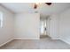 Neutral carpeted bedroom with a window and access to other rooms at 5847 Harrison St, New Port Richey, FL 34653