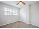 Bedroom featuring neutral carpet, a ceiling fan, and a closet at 5847 Harrison St, New Port Richey, FL 34653